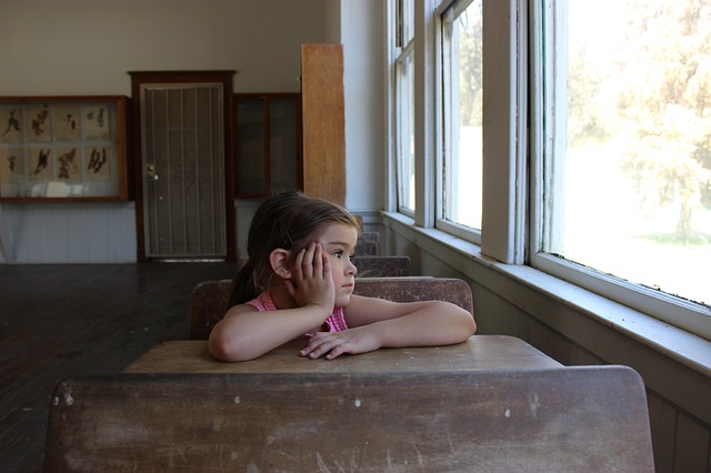 Insensitive Criticism can adversely Affect a child's Development Little girl lost in thought in a classroom
