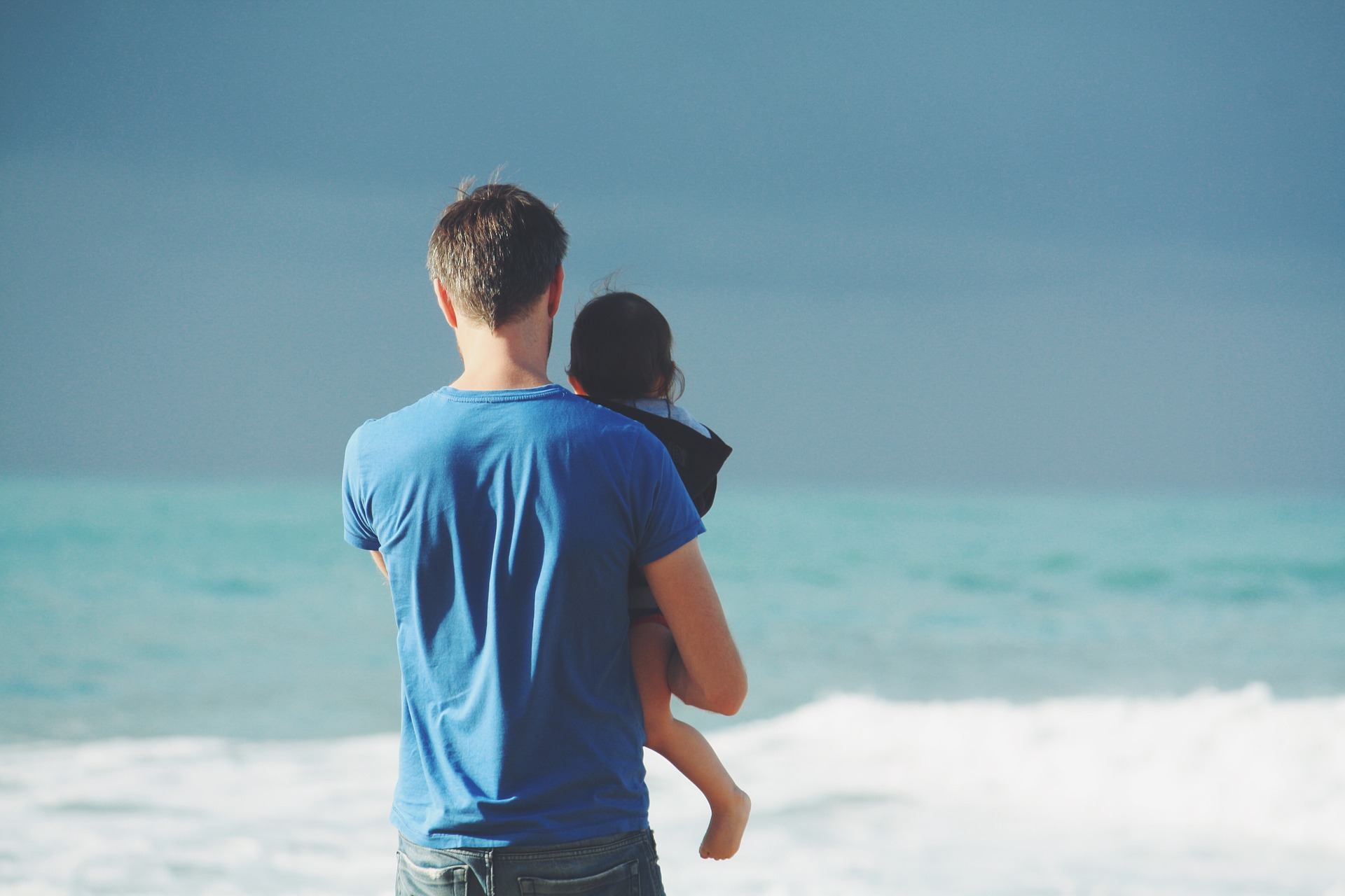 Secured in the protective circle of your Arms Father and Daughter on the Beach